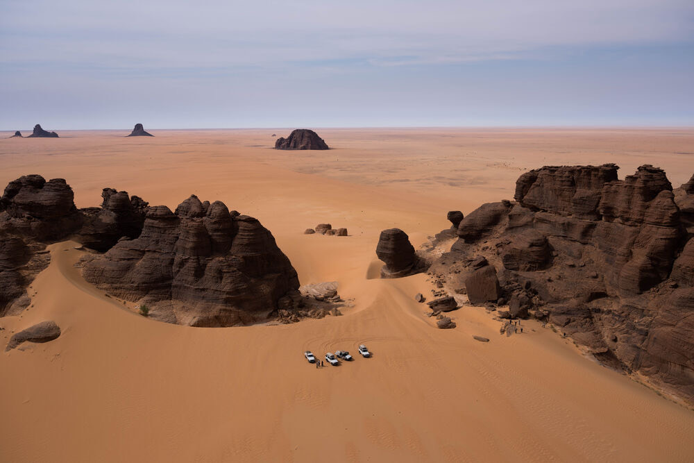 4x4s parked among the Ennedi sandstone, Chad